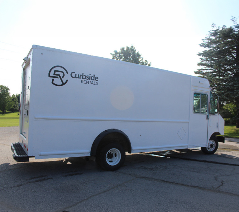 Curbside Rentals step van, rear side view with logo